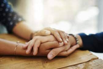 Closeup shot of two unrecognizable people holding hands in comfort