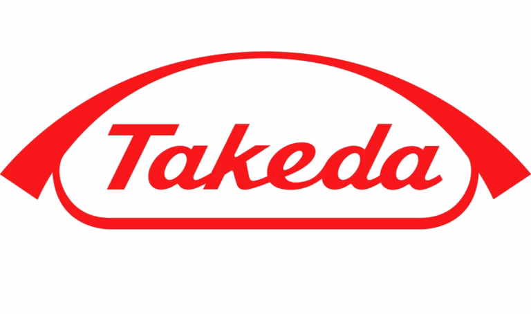 The image shows the Takeda logo, featuring the word Takeda in red script inside a red outlined shape resembling a curved arch or capsule on a white background.