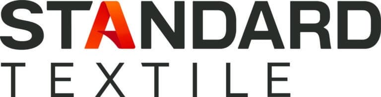 The image shows the logo of Standard Textile. The word STANDARD is in bold black uppercase letters, with the letter A in a gradient of red and orange. Below, TEXTILE appears in smaller black uppercase letters.