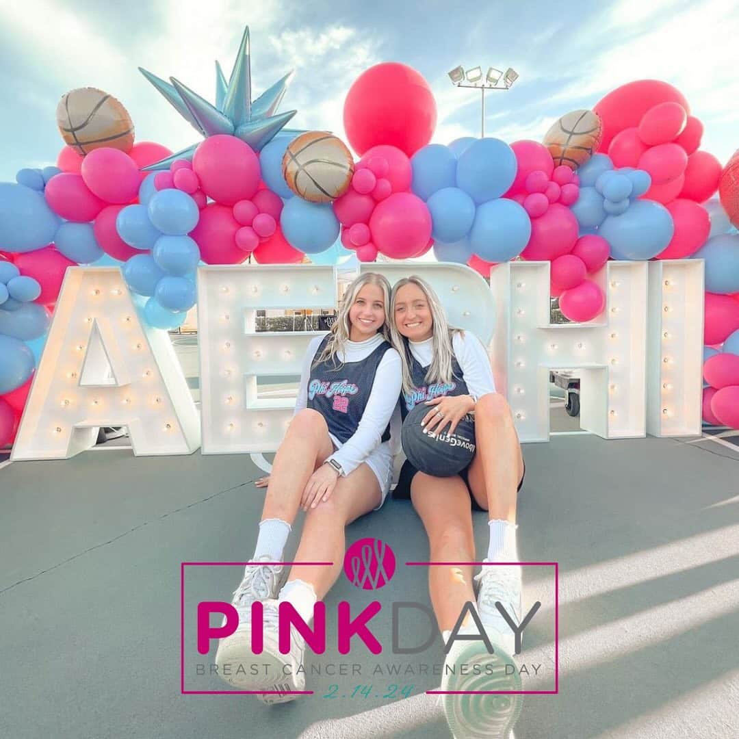 Two young women sit together smiling in front of large light-up Greek letters and a balloon arch with pink and blue balloons. A Sharsheret Pink Day 2026 Breast Cancer Awareness banner overlays the bottom of the image.